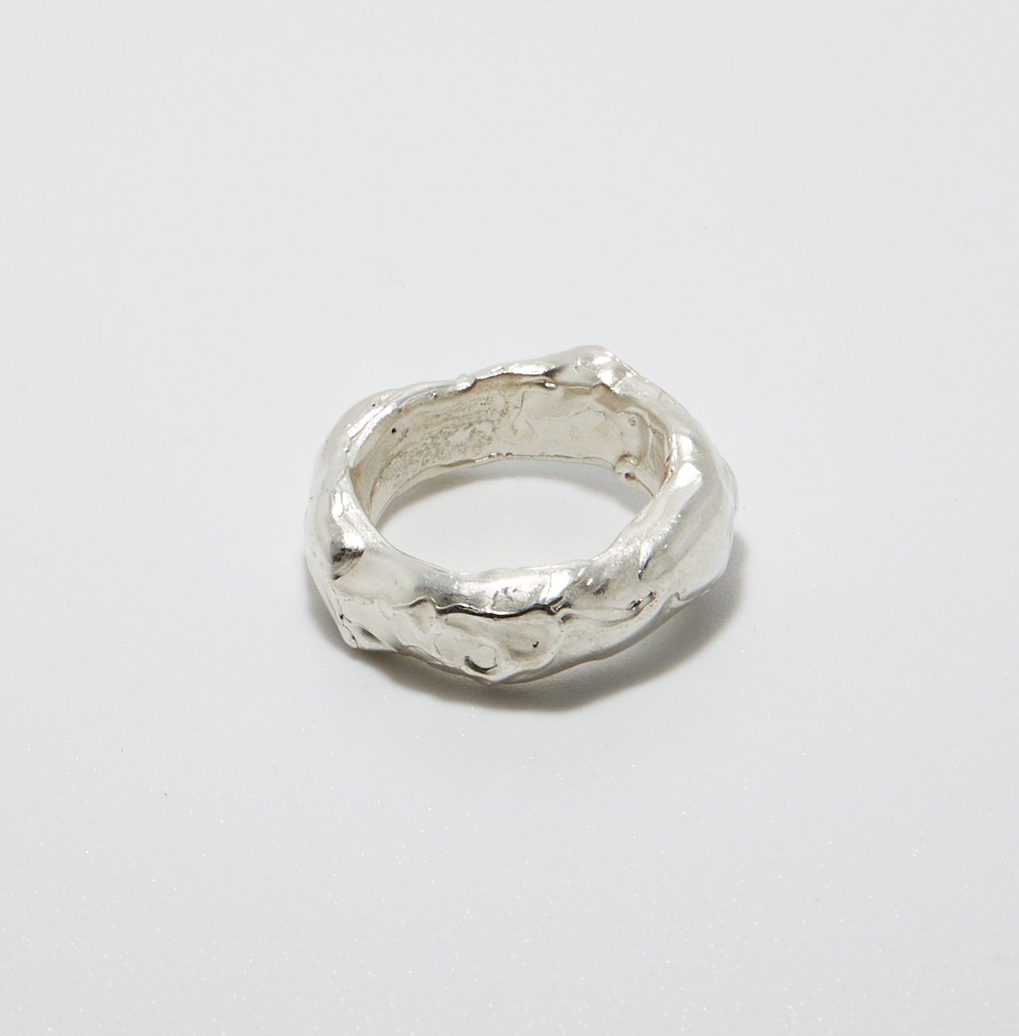 Sterling Silver ring with a textured surface on a light grey background