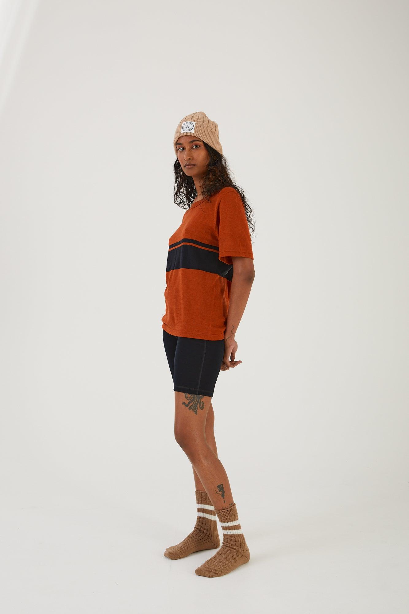 A person wearing merino wool socks, merino wool biker shorts, a merino wool t-shirt and a merino wool beanie