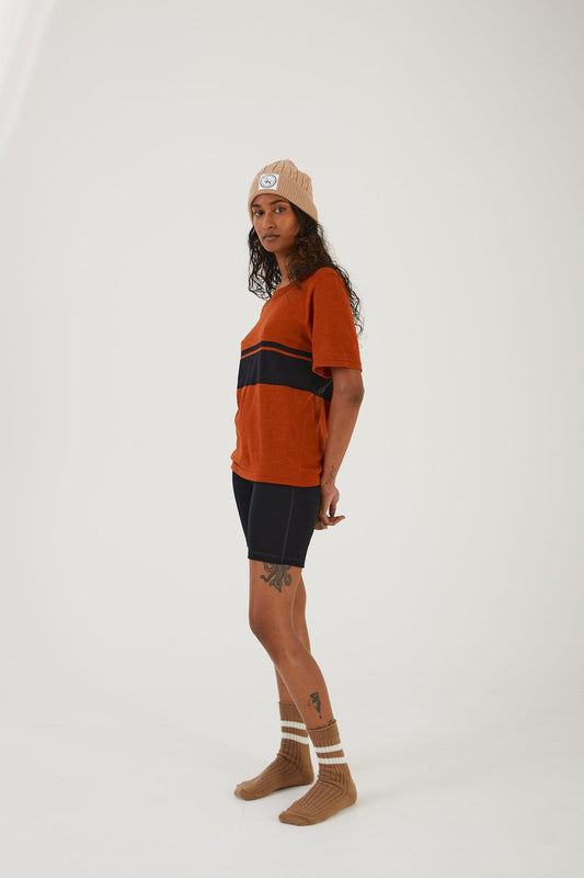 A person wearing merino wool socks, merino wool biker shorts, a merino wool t-shirt and a merino wool beanie