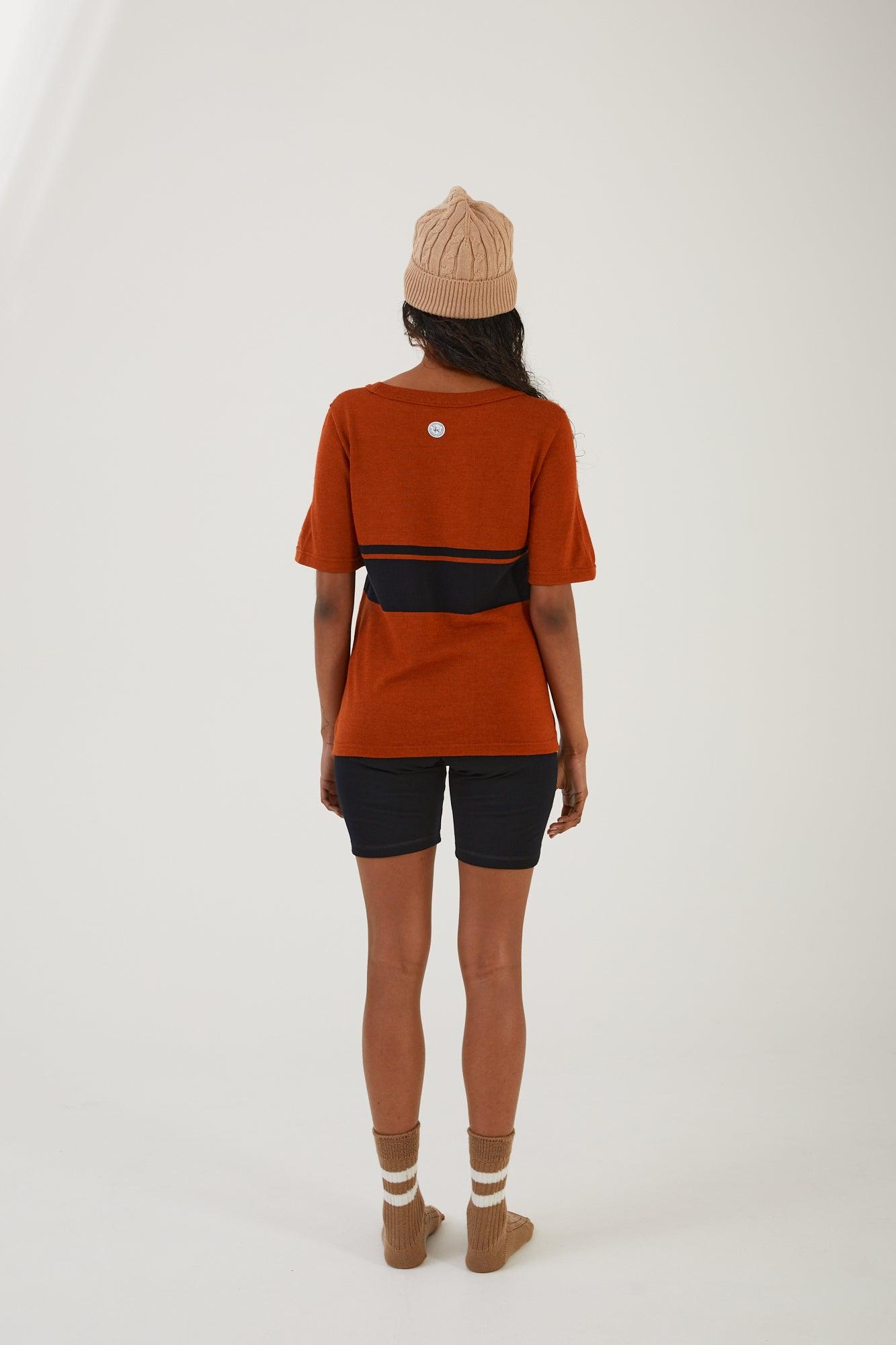 A person wearing merino wool socks, merino wool biker shorts, a merino wool t-shirt and a merino wool beanie