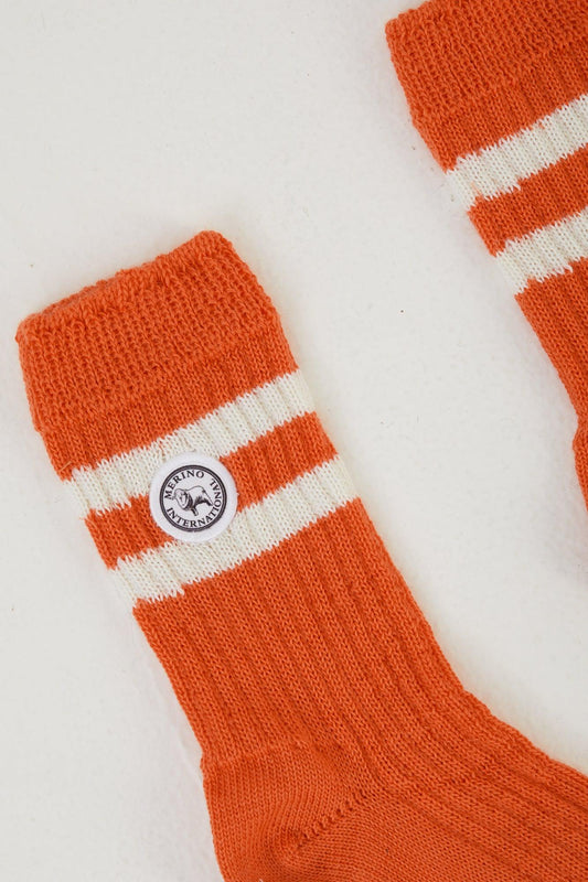 Zoomed in image of rust coloured merino wool socks laid out flat