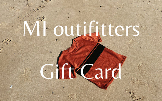 merino wool tshirt flat lay on sand with text overlay "MI outfitters Gift Card"