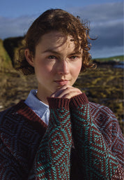 Person wearing a patterned sweater in a natural setting