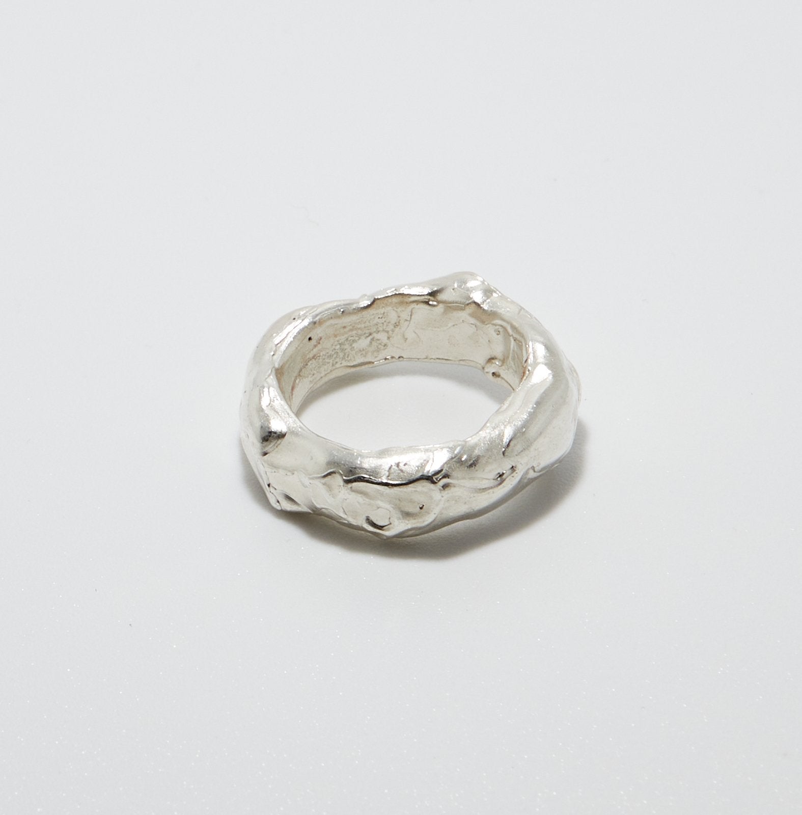Sterling Silver ring with a textured surface on a light grey background