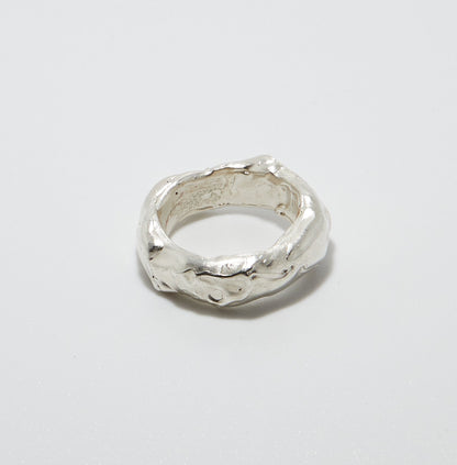 Sterling Silver ring with a textured surface on a light grey background