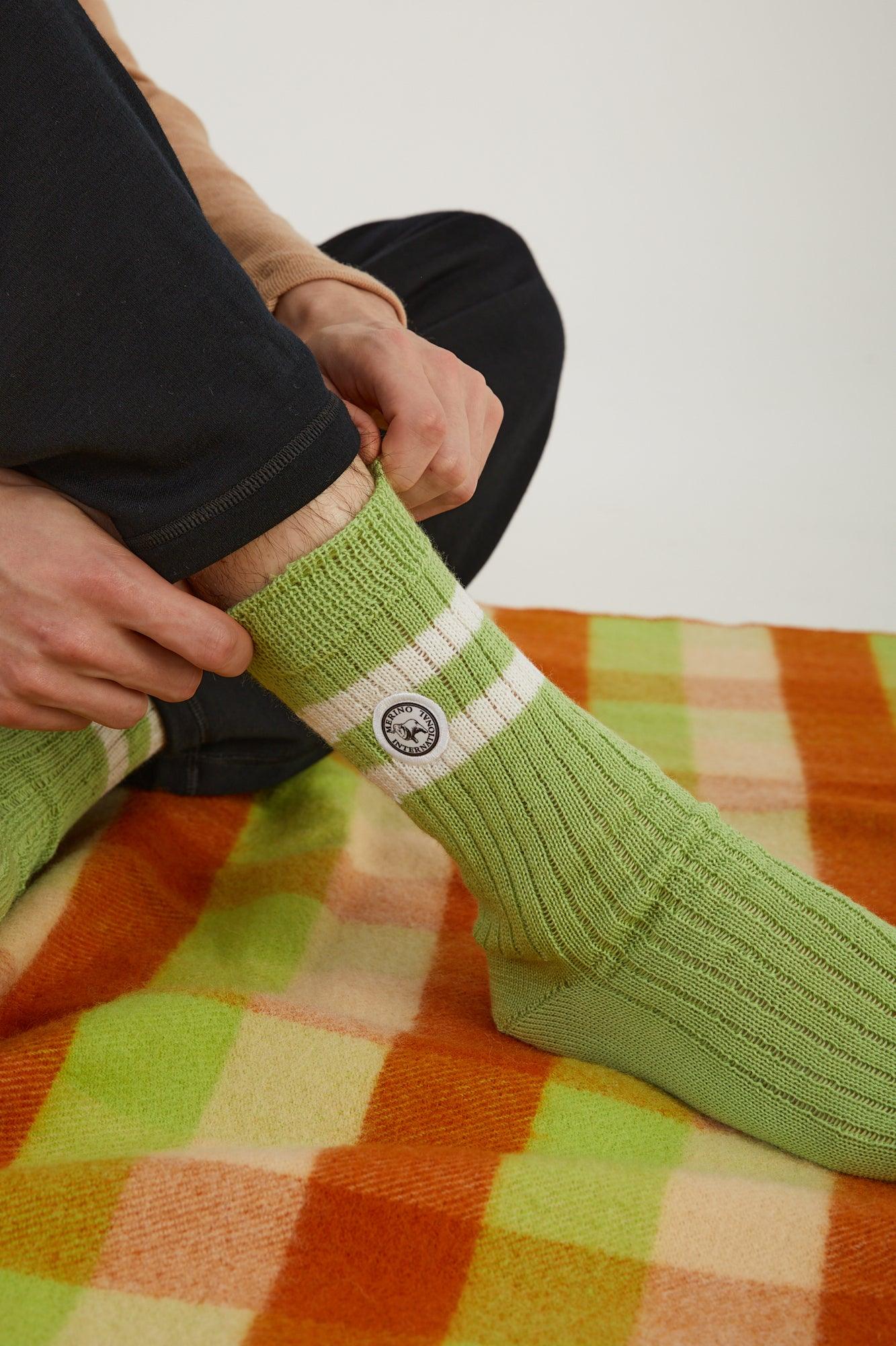 Close up of a person putting on merino wool socks 