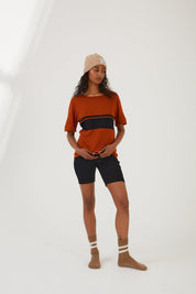 A person wearing merino wool socks, merino wool bike shorts, a merino wool top and a merino wool beanie