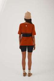 A person wearing merino wool socks, merino wool biker shorts, a merino wool t-shirt and a merino wool beanie