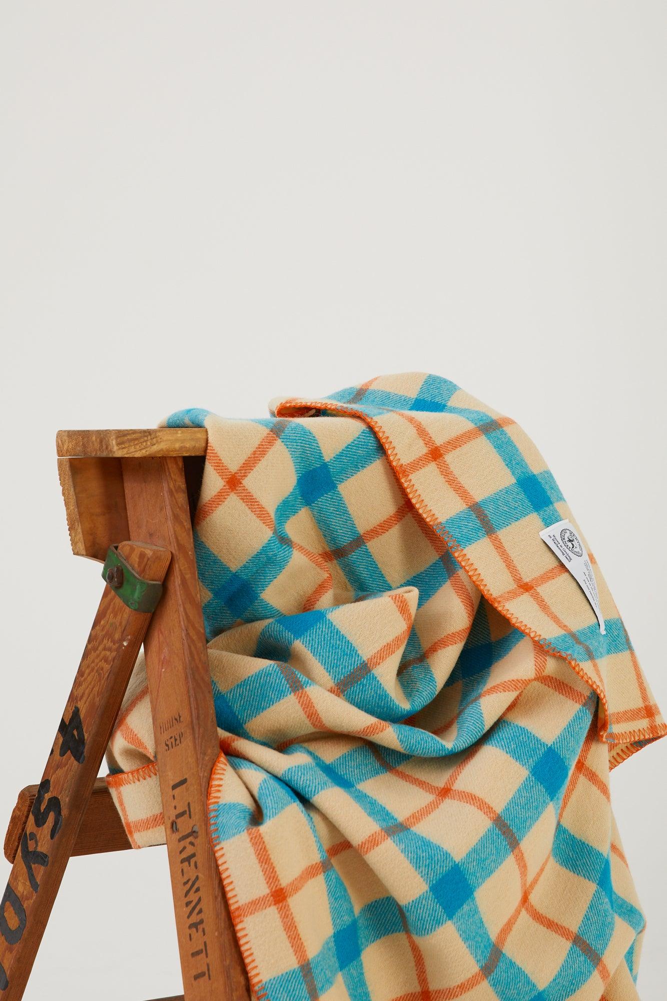 Close up of a wool blanket draped over a wooden step ladder