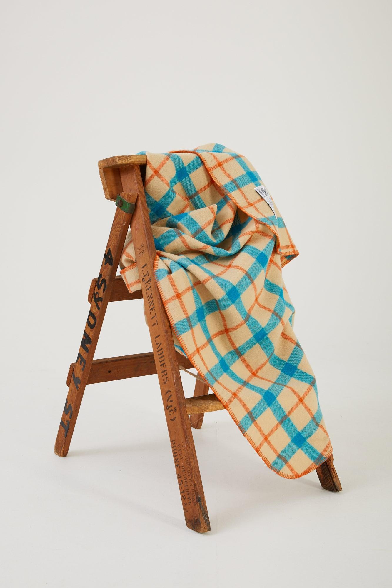 Wool blanket draped over a wooden step ladder