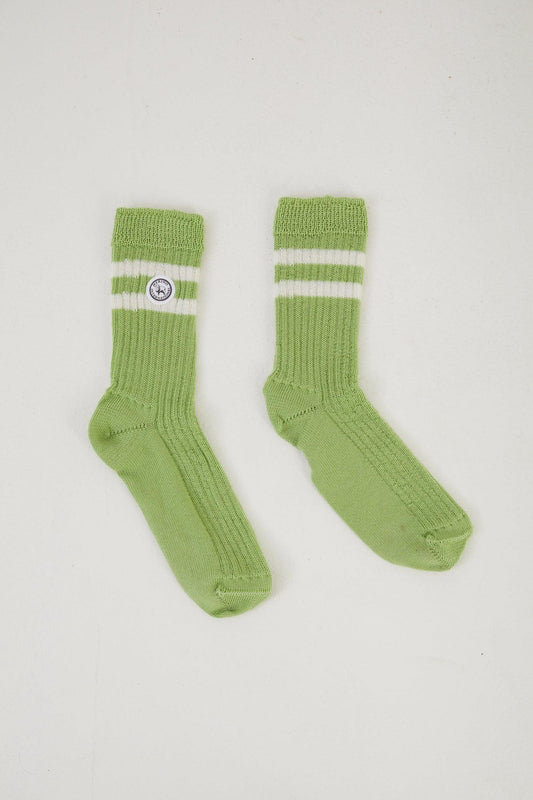 Flat lay of green merino wool socks with a retro double stripe