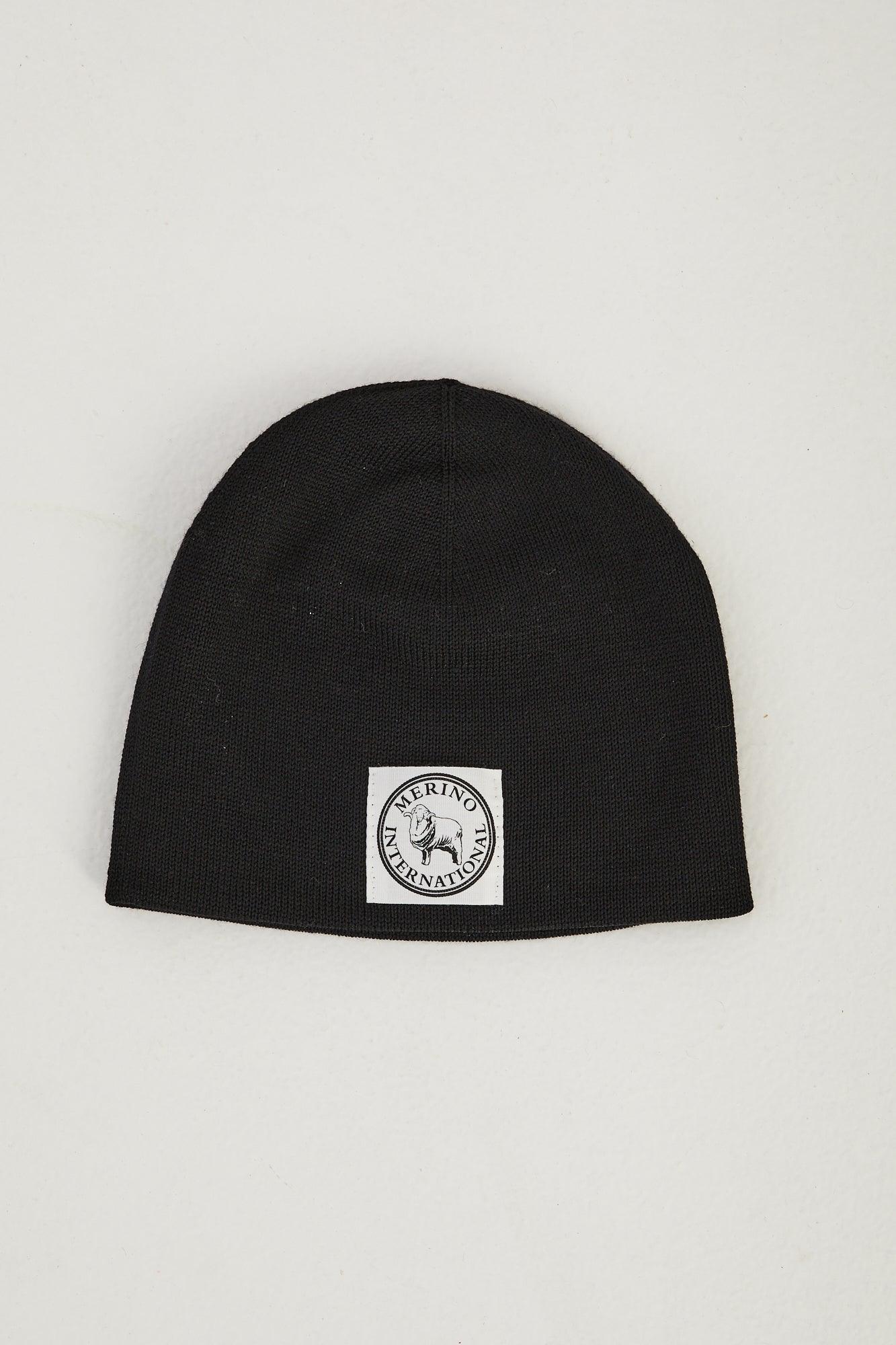 Flat lay of a black merino wool beanie 